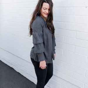 Grey cardigan with ruffle detailing on sleeves